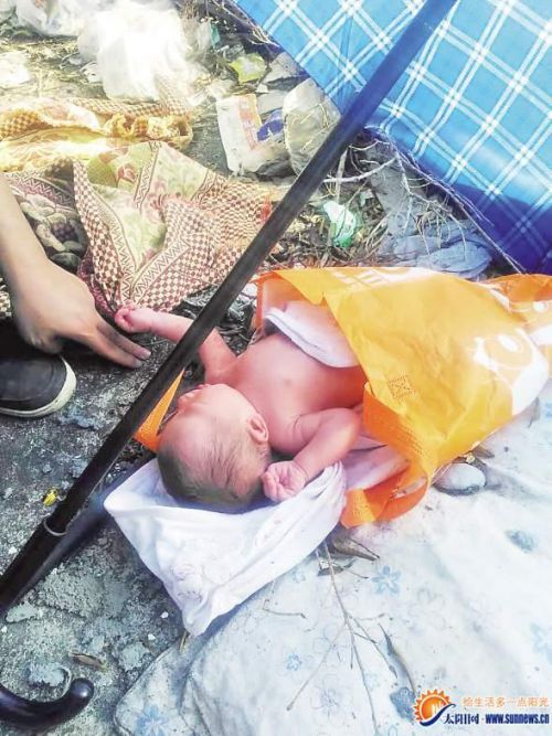 健康男婴被遗弃废弃物旁 被装在橙色购物袋内