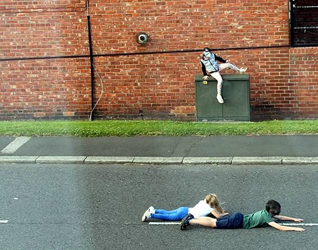 惊险一幕：英国熊孩子不顾危险躺在路中间玩耍